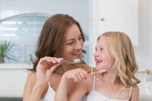 mom and daughter brushing teeth Anthony DeBenedictis, D.D.S. Mt Vernon, NY